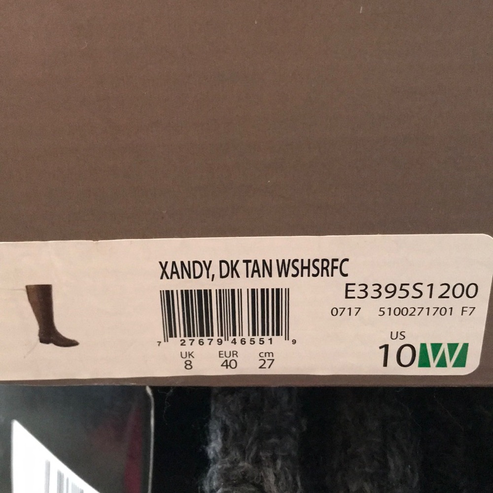 Brown knee high flat boots .